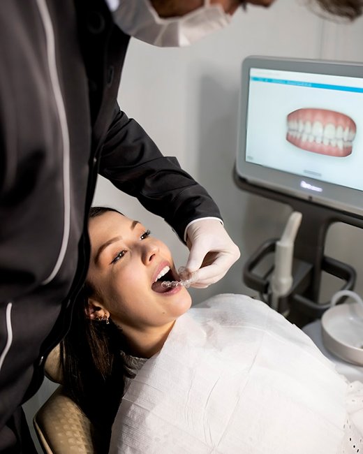 image (dentist examining patient using digital dental technology at gardencity smiles, yelahanka)
